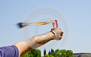 Man using spear thrower throwing rock nature amusement