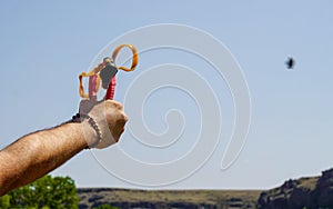 Man using spear thrower throwing rock nature amusement