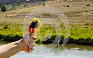 Man using spear thrower throwing rock nature amusement