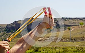 Man using spear thrower throwing rock nature amusement