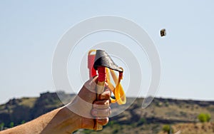 Man using spear thrower throwing rock nature amusement