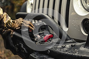 A Man Using SUV Electric Winch to Recover His Vehicle