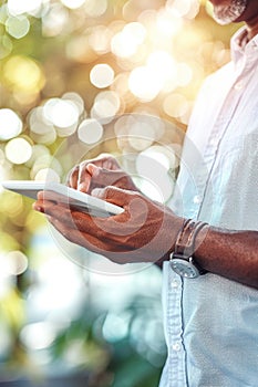 Man using a tablet with a bokeh light background