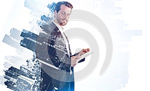 Man using tablet computer in city