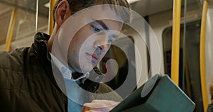 Man Using Tablet PC in Metro Train