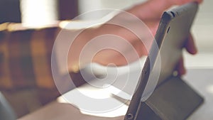 Man using tablet. Person drinking morning coffee and checking internet.