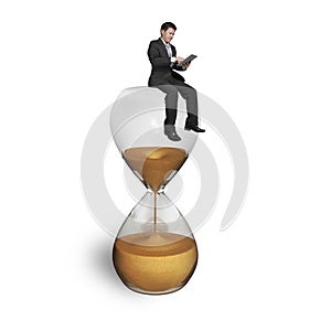 Man using tablet and sitting on hourglass