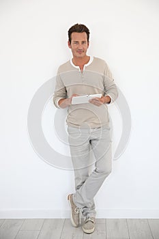 Man using tablet standing isolated