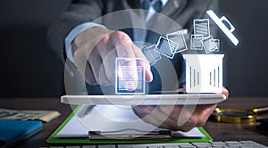 Man using tablet. Trash can and files. Delete files