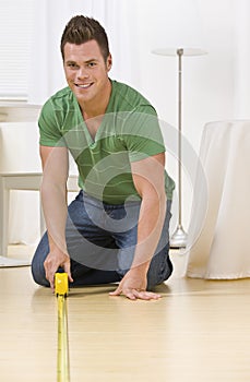 Man Using Tape Measure