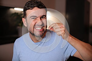 Man using a toothpick after lunch