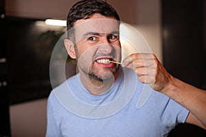 Man using a toothpick after lunch