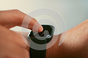 Man using trendy smart watches mobile app on touch screen.New gadget to view incoming messages and calls to a mobile phone.