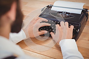 Man using typewriter at desk in office