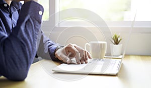 A man using and typing keyboard of laptop computer communicates on internet technology