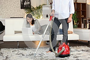 Man using a vacuum cleaner photo