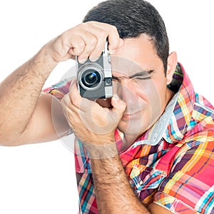 Man using a vintage looking compact camera on white