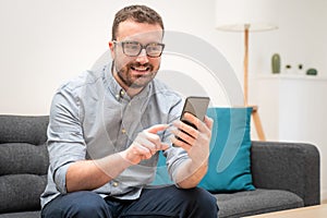 Man using virtual assistant and texting on mobile phone