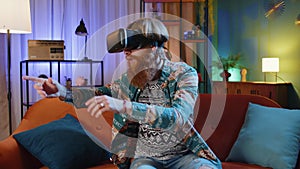 Man using virtual reality futuristic technology headset to play simulation 3D video game at home