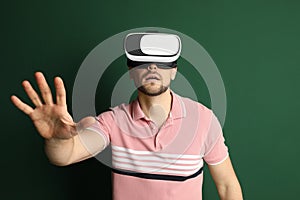 Man using virtual reality headset on green background