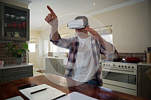 Man using virtual reality headset in kitchen