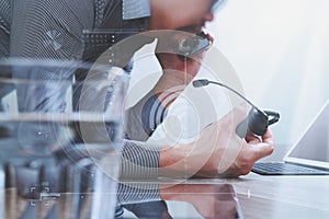 Man using VOIP headset with digital tablet computer docking smart keyboard, concept communication, it support, call