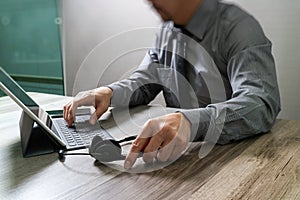 Man using VOIP headset with digital tablet computer docking smart keyboard, concept communication, it support, call center and cu