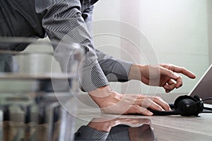 Man using VOIP headset with digital tablet computer docking smart keyboard, concept communication, it support, call center and cu