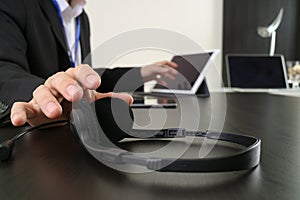 Man using VOIP headset with digital tablet and laptop computer a