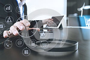 Man using VOIP headset with digital tablet and laptop computer a