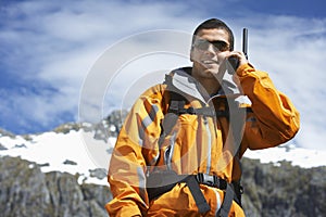 Man Using Walkie Talkie Against Mountain