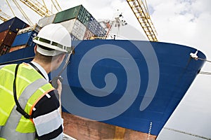 Man Using Walkie Talkie At Container Terminal