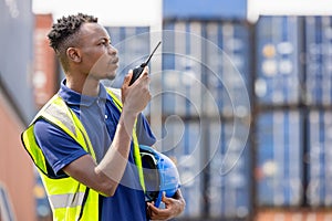 Man Using Walkie Talkie At Container Terminal, Industrial worker is controlling container loading