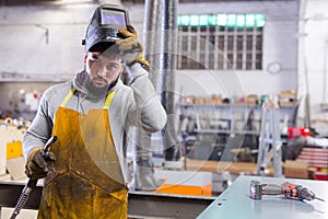 Man using welder for construction work at the workshop