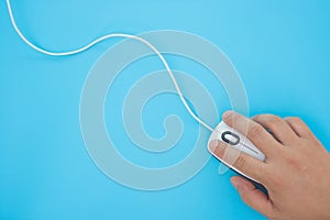 Man using a white mouse on blue background