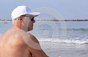 Man on vacation sunbathing on the beach