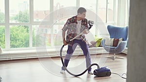 Man vacuuming and dancing