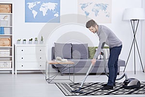 Man vacuuming in a living room