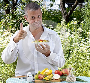 The man the vegetarian eats salad photo