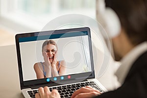 Man video calling woman, smiling teen girl on laptop screen