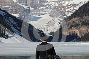 Man on banks of Lake Louise, Alberta, Canada