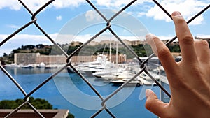 Man views yachts behind fence, corrupt official looks at confiscated property