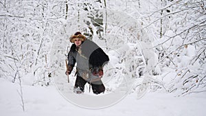 Man viking going in the winter forest.