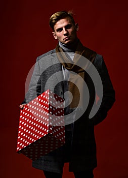 Man in vintage style with present. Guy with brutal face