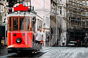 Man in a vintage tram on the Taksim Istiklal street in Istanbul. Man on public transport. Old Turkish tram on Istiklal street, photo