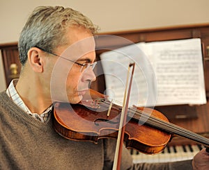 man and violin with score