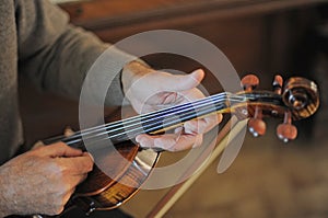 man and violin with score