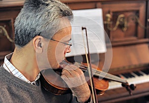 man and violin with score
