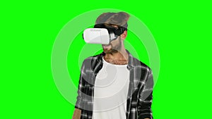 Man in virtual reality glasses. Close up. Green screen