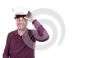 Man with virtual reality glasses on his head on white background with side copy space